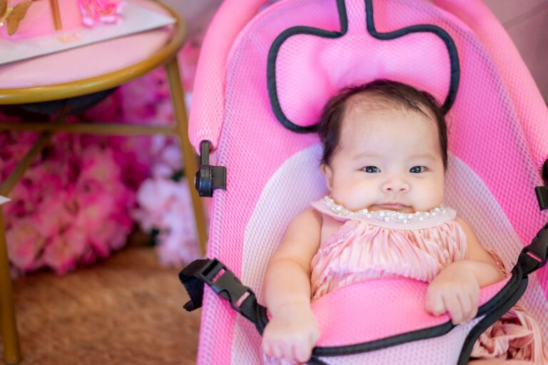Baby liegt entspannt in einer weichen Babywippe im Wohnzimmer